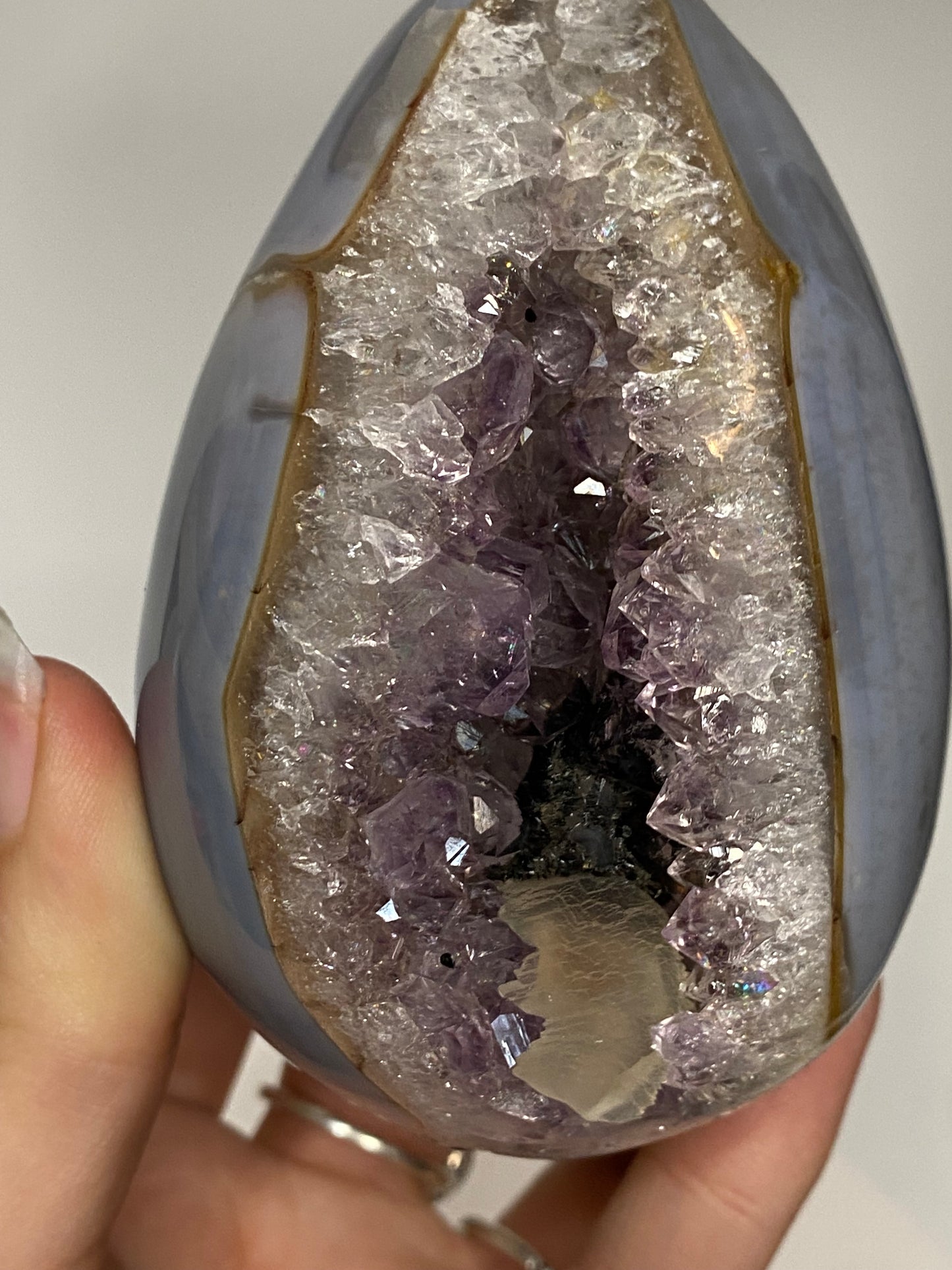 Blue agate and amethyst egg with calcite and tourmaline