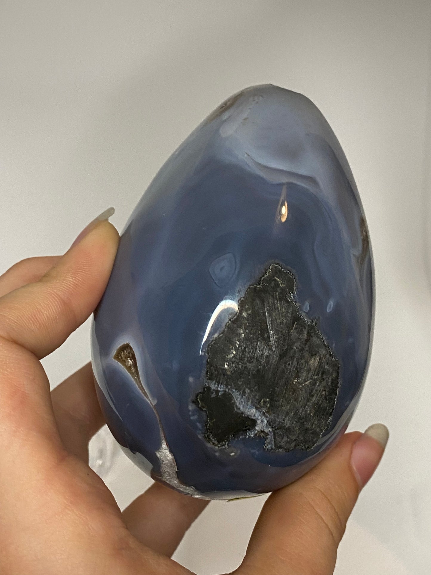 Blue agate and amethyst egg with calcite and tourmaline