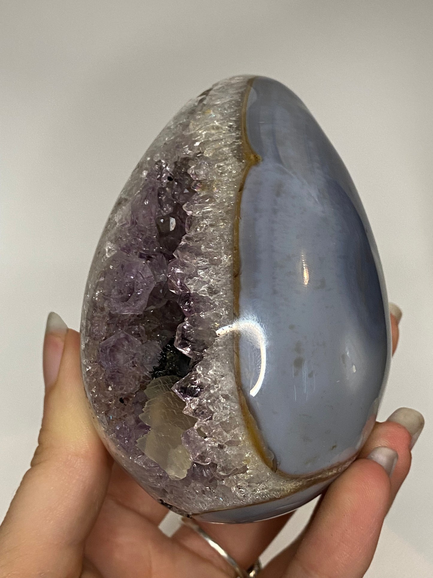 Blue agate and amethyst egg with calcite and tourmaline