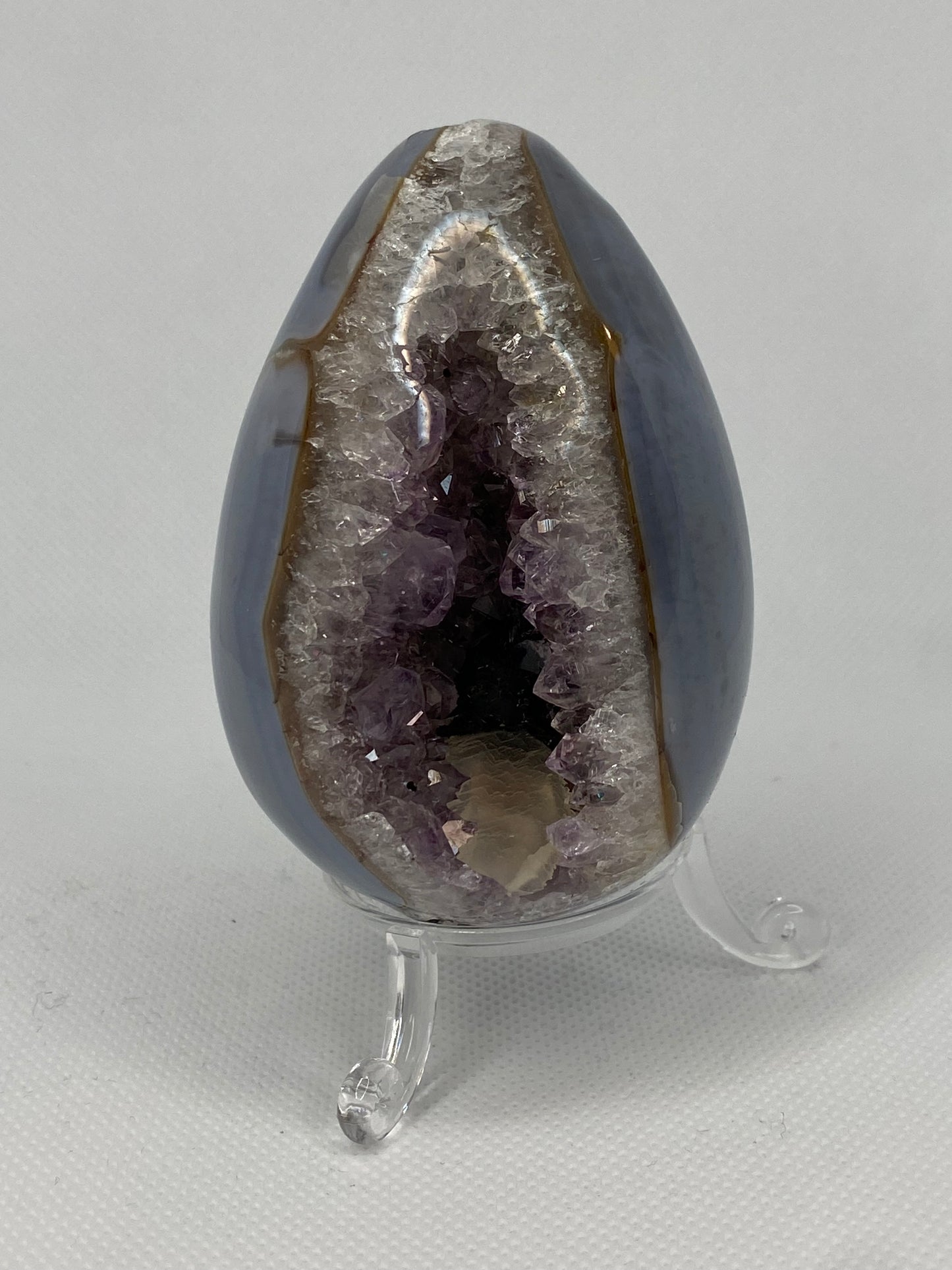 Blue agate and amethyst egg with calcite and tourmaline