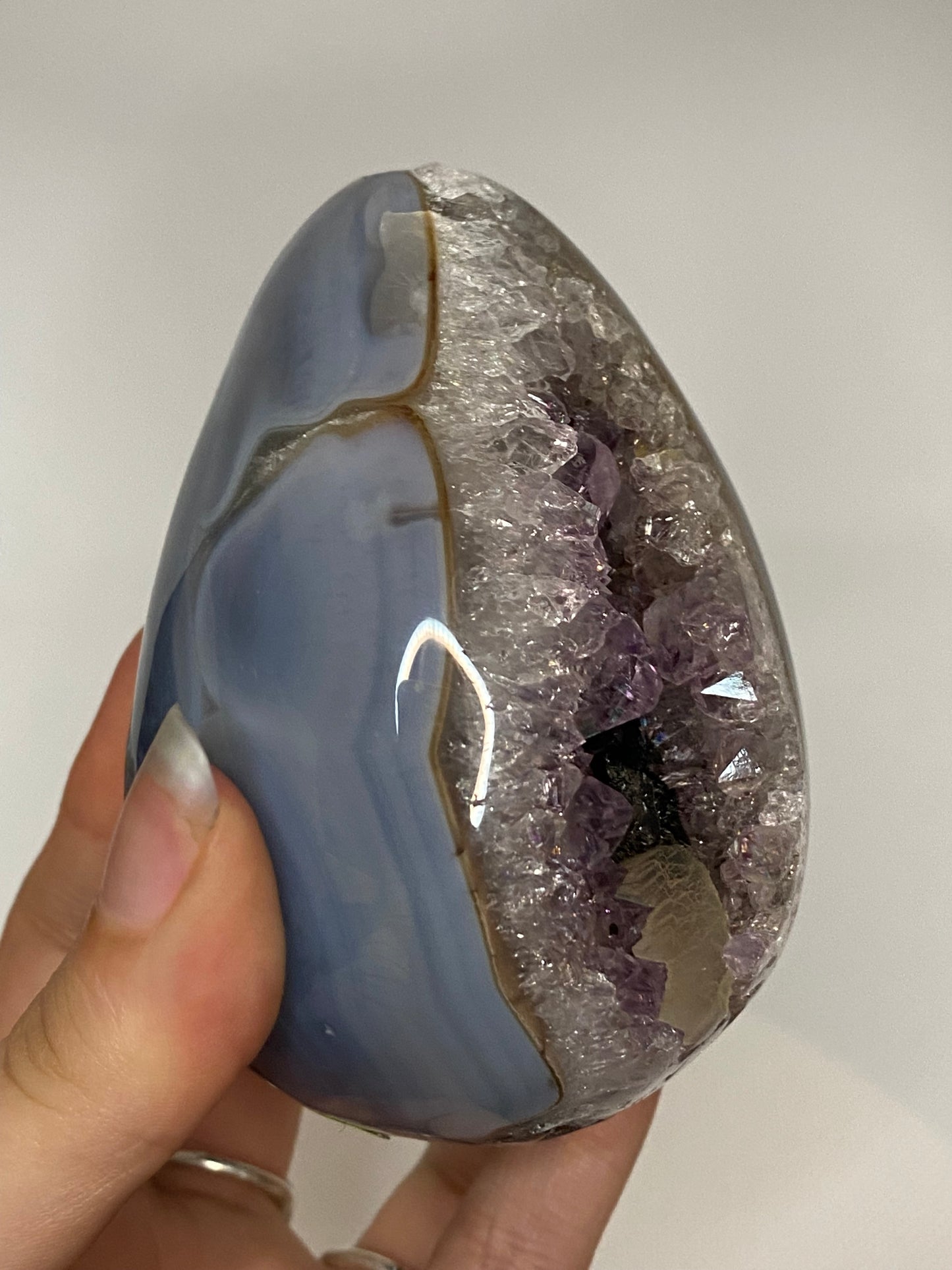 Blue agate and amethyst egg with calcite and tourmaline